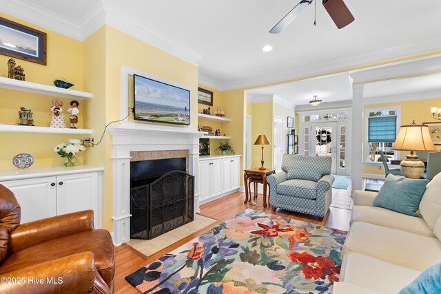 dining area featuring crown molding, ceiling fan with notable chandelier, and light hardwood / wood-style flooring