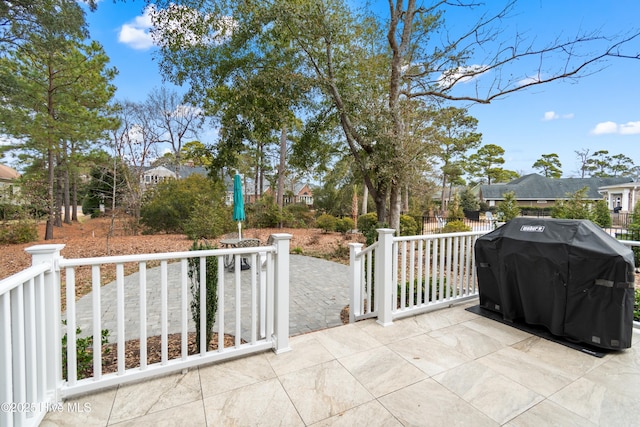 view of patio / terrace with a residential view and a grill