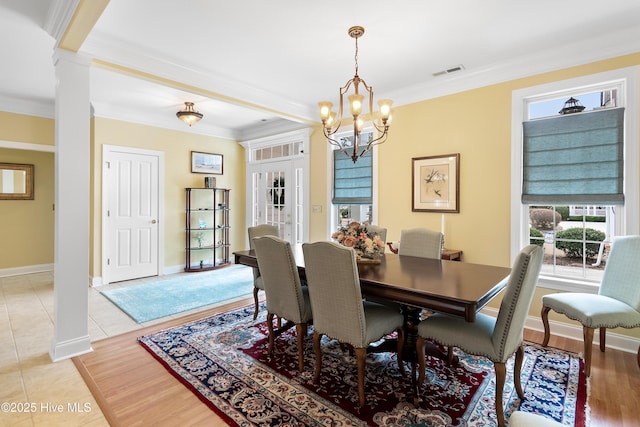 dining area with visible vents, crown molding, decorative columns, and plenty of natural light