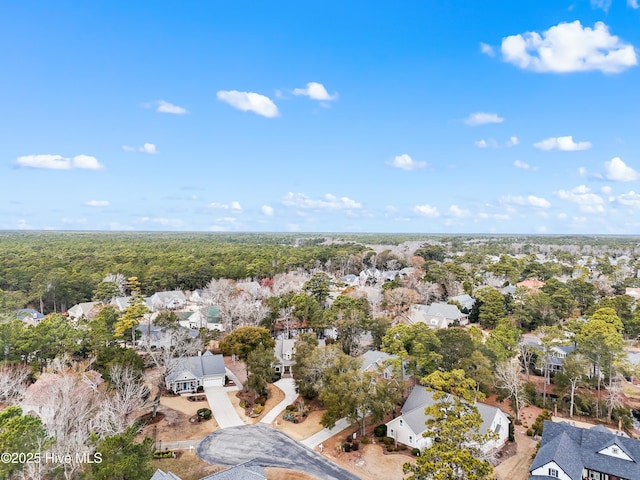 birds eye view of property featuring a residential view and a wooded view
