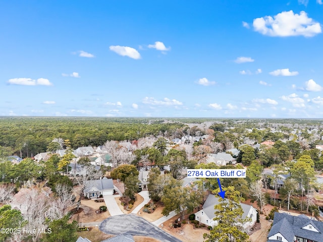 birds eye view of property featuring a forest view and a residential view