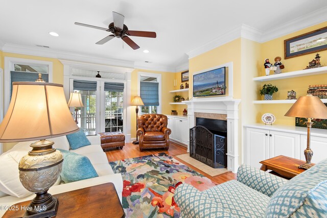 dining area with crown molding, plenty of natural light, an inviting chandelier, and light hardwood / wood-style flooring