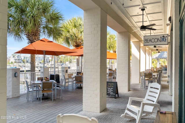 view of patio with a ceiling fan and outdoor dining area