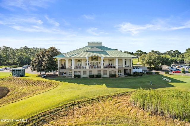 view of front of house with a balcony and a front yard