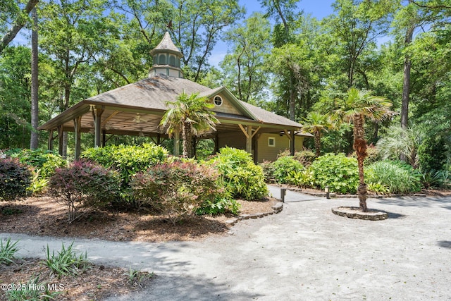 exterior space featuring roof with shingles