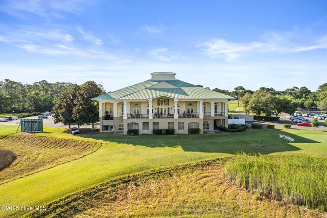 back of property featuring a lawn