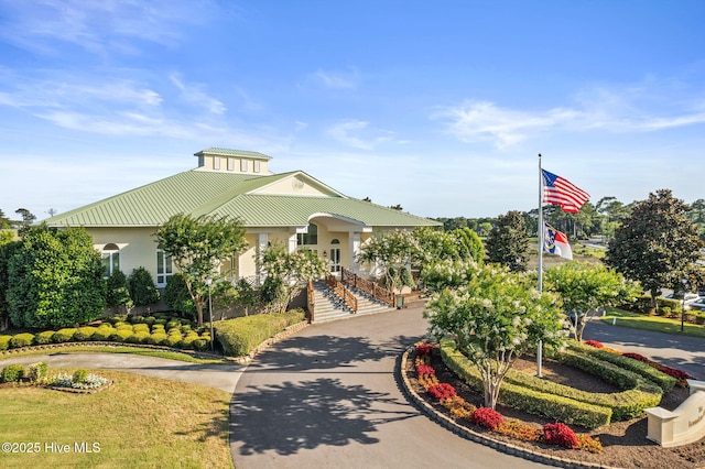 view of home's community with curved driveway and stairs