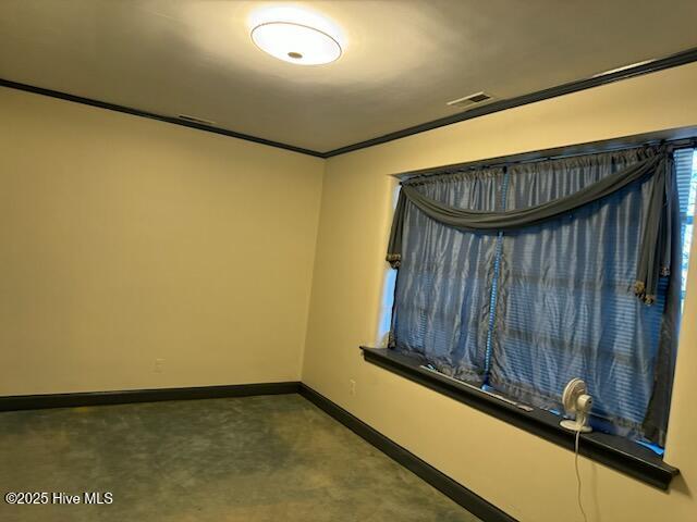 unfurnished room with crown molding