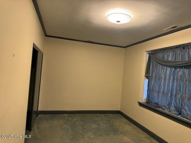 empty room featuring ornamental molding