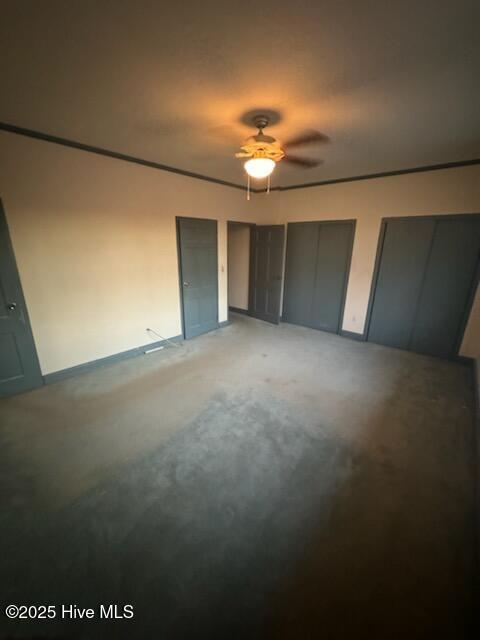 unfurnished bedroom featuring multiple closets