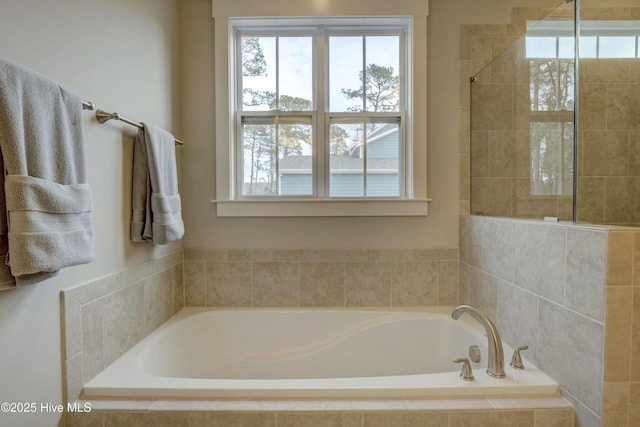 bathroom featuring a relaxing tiled tub