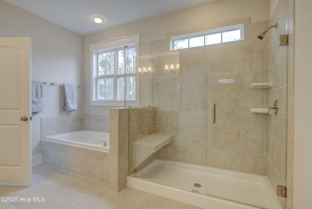 bathroom with tile patterned floors and independent shower and bath