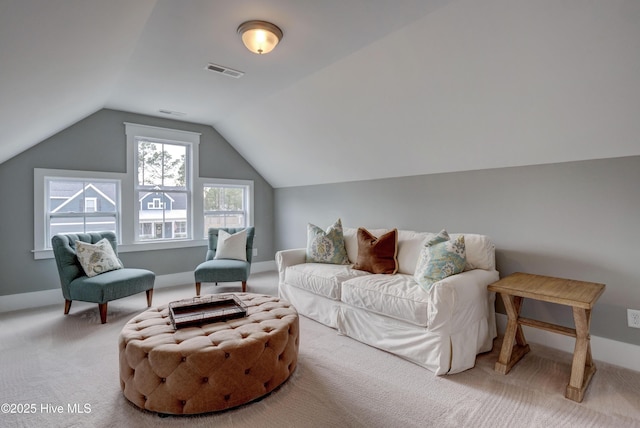 living area with light carpet and vaulted ceiling