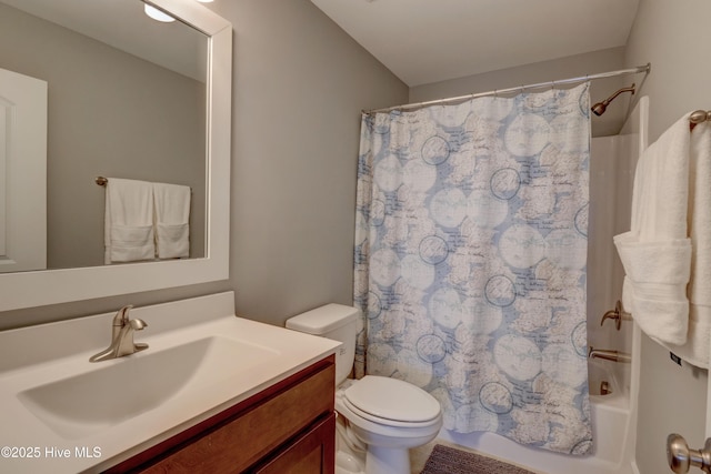 full bathroom with vanity, shower / bath combination with curtain, and toilet