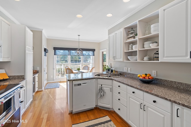 kitchen with white dishwasher, sink, and white cabinets