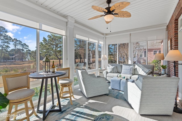 sunroom featuring ceiling fan and a wealth of natural light