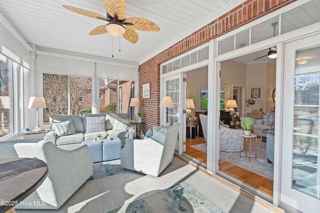 sunroom featuring ceiling fan