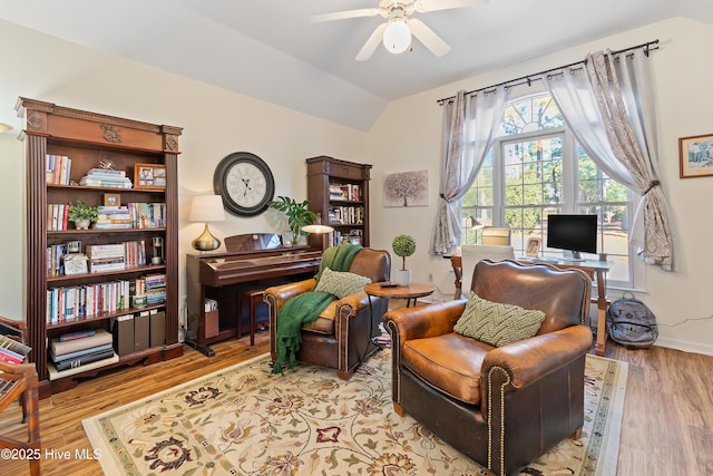 living area with lofted ceiling, light wood-type flooring, and ceiling fan