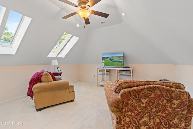 sitting room featuring ceiling fan, light colored carpet, and vaulted ceiling