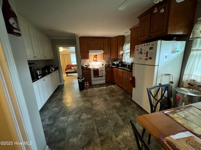 kitchen with ventilation hood, white appliances, sink, and a wealth of natural light