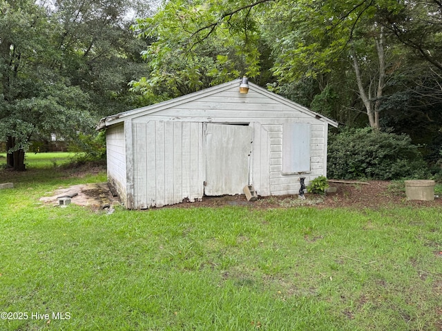 view of outbuilding featuring a lawn