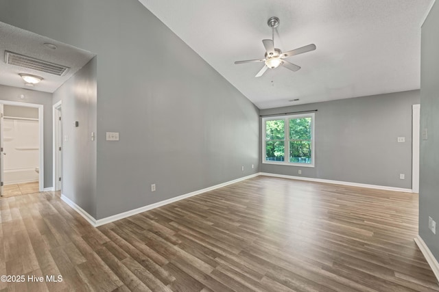 interior space featuring wood-type flooring, a textured ceiling, ceiling fan, and lofted ceiling