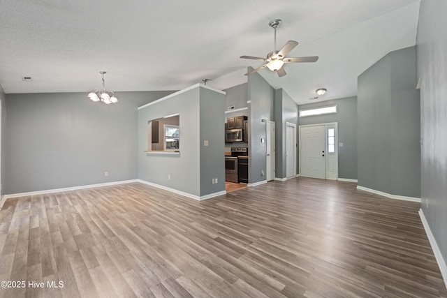 unfurnished living room featuring high vaulted ceiling, wood-type flooring, and ceiling fan with notable chandelier