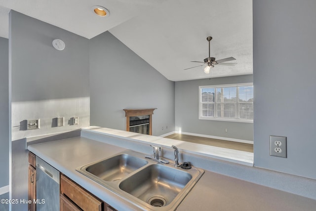 kitchen with ceiling fan, lofted ceiling, stainless steel dishwasher, and sink