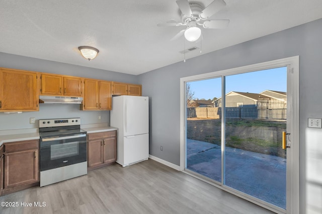 kitchen with ceiling fan, white refrigerator, light hardwood / wood-style flooring, and electric range