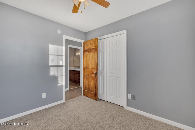 unfurnished bedroom featuring carpet floors, a closet, and ceiling fan