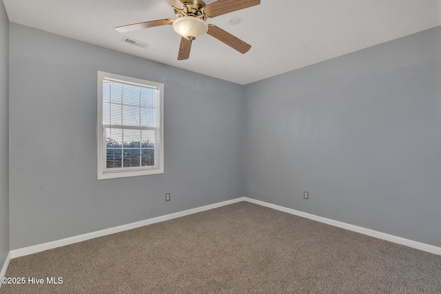 spare room with carpet floors and ceiling fan