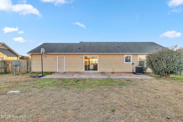 rear view of property featuring a patio area, cooling unit, and a yard