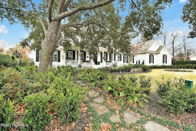 view of front of home with a front yard and covered porch