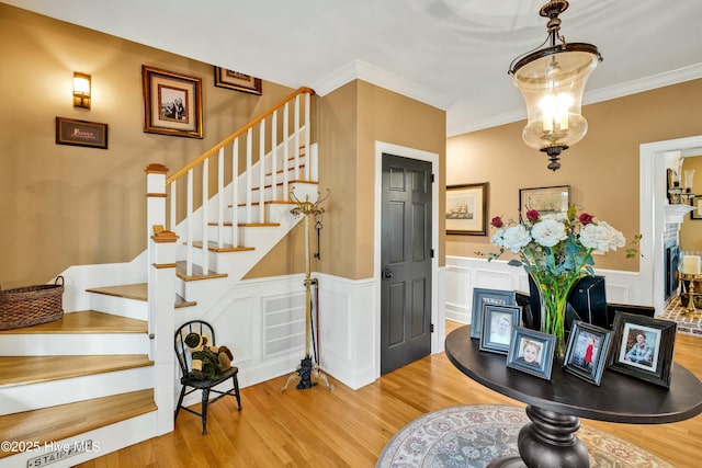 interior space with a fireplace, hardwood / wood-style floors, and crown molding