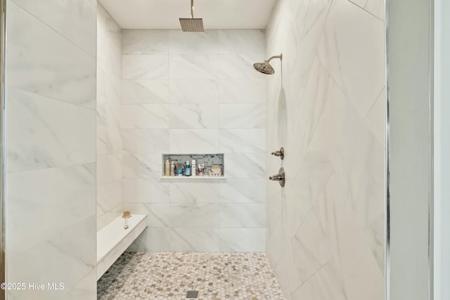 bathroom with a tile shower