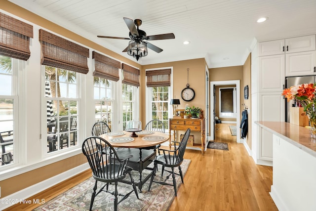 dining room featuring light wood-type flooring, ceiling fan, and wooden ceiling