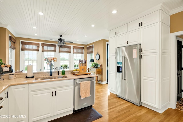 kitchen featuring white cabinets, light hardwood / wood-style floors, stainless steel appliances, ceiling fan, and sink