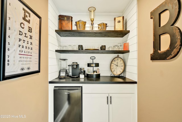 bar featuring fridge and white cabinets