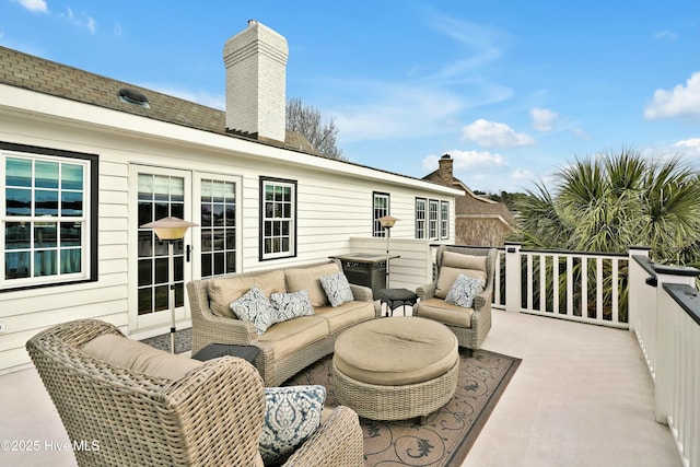 wooden terrace with outdoor lounge area