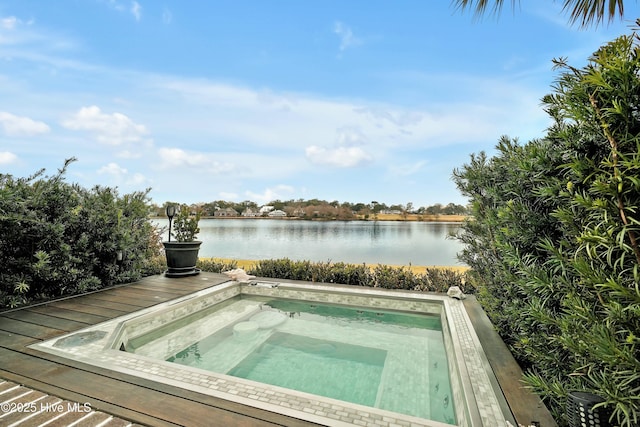 view of pool with a water view