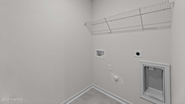 clothes washing area with hookup for a washing machine, gas dryer hookup, and electric dryer hookup