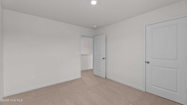 unfurnished bedroom featuring light carpet