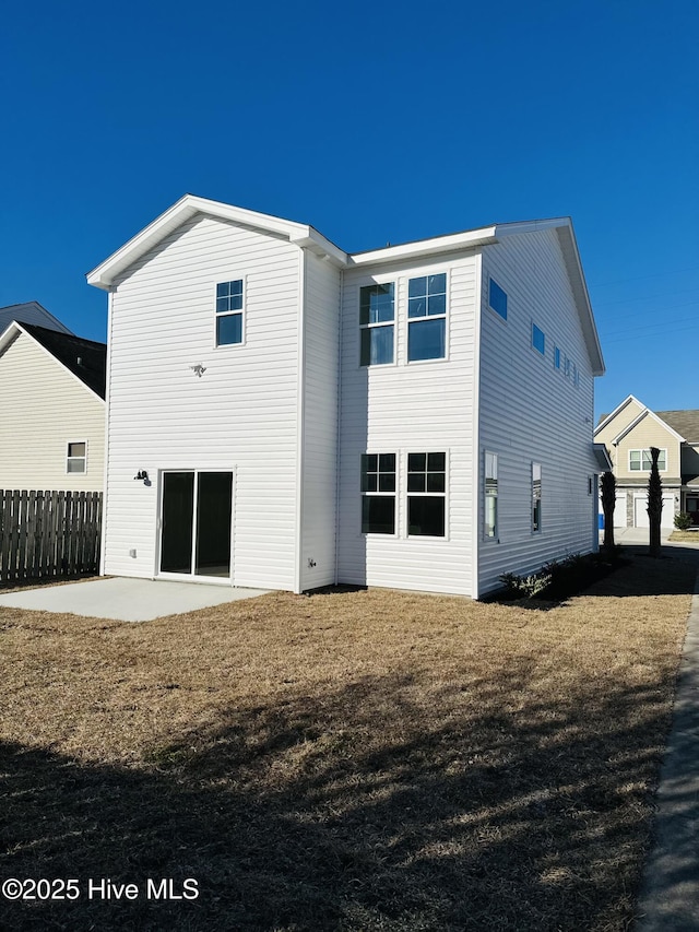 rear view of property with a patio area and a lawn