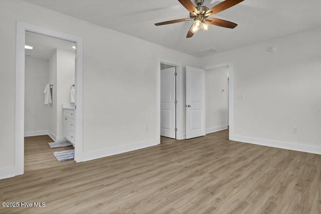 unfurnished bedroom with ceiling fan, ensuite bathroom, and light hardwood / wood-style flooring