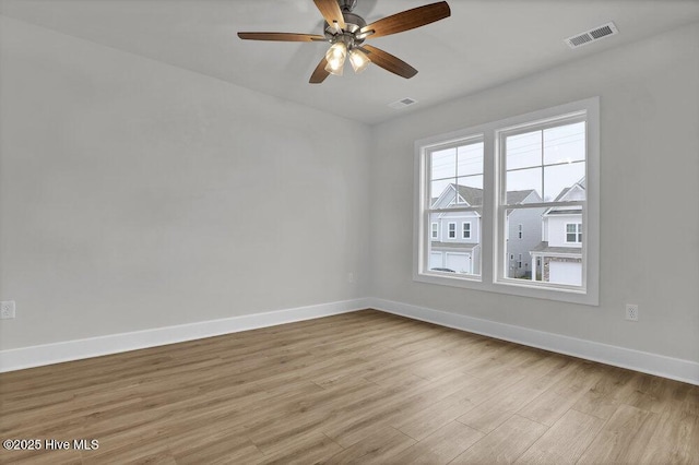 unfurnished room with light wood-type flooring and ceiling fan