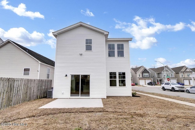 rear view of house featuring central AC unit and a patio