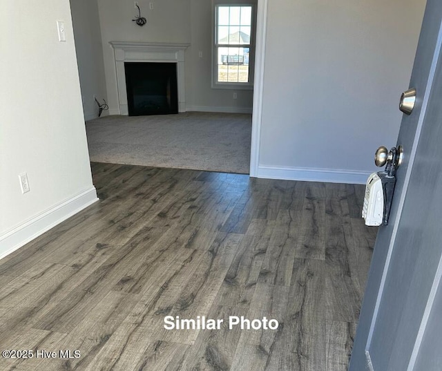 unfurnished living room with dark hardwood / wood-style floors