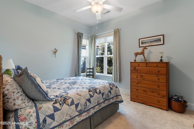 bedroom with ceiling fan and light carpet