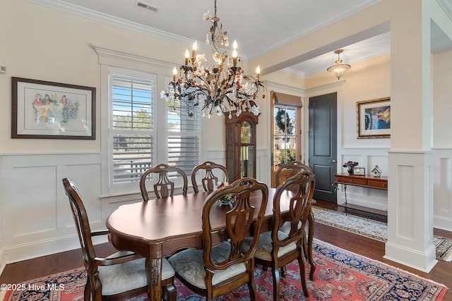 dining area featuring ornamental molding and dark wood-type flooring