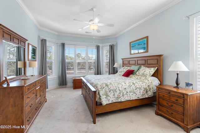 carpeted bedroom with ornamental molding and ceiling fan